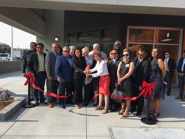 people cutting ribbon