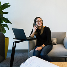 girl sitting on sofa with laptop